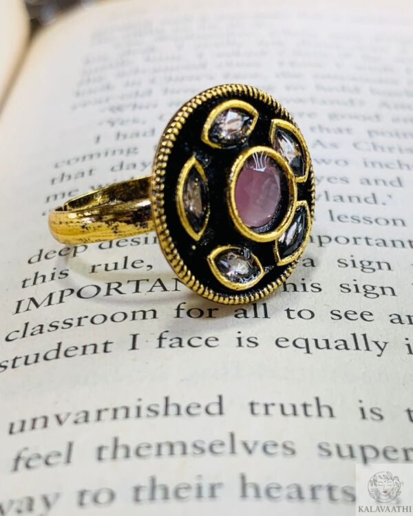 Adjustable ethnic ring with pink gem and teardrop accents.