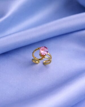 Gold-tone anti-tarnish adjustable ring with pink American Diamond stone on satin background