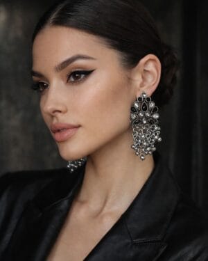 Floral oxidised silver ghungroo drop earrings with stone detailing worn with black outfit