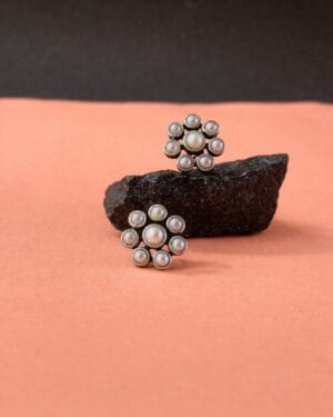 Pearl cluster oxidised silver stud earrings with floral design on peach background