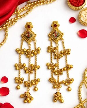 Antique gold ghungroo earrings with red stone detailing and layered bell chains