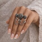 Oxidized multi finger chain ring with pearl charms on woman hand