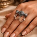 Oxidized vintage multi finger chain ring with pearl charms worn on woman's hand