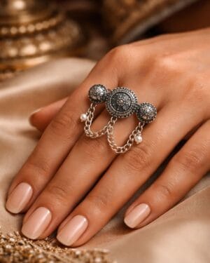 Oxidized vintage multi finger chain ring with pearl charms worn on woman's hand